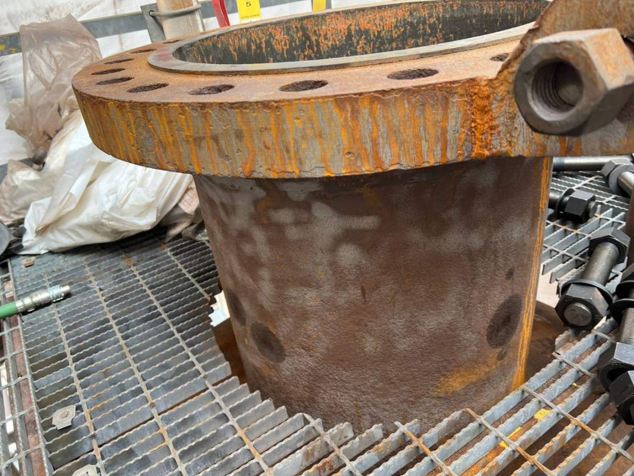 Flanged nozzle before laser cleaning, surface obscured by corrosion