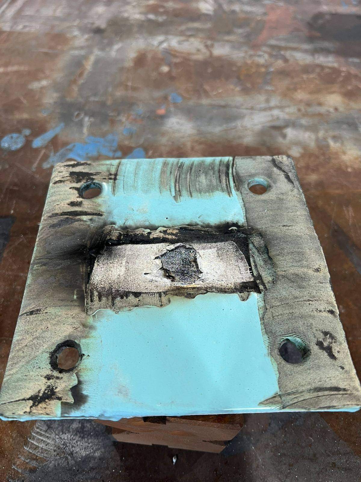 Coating removal test plate showing partially stripped coating